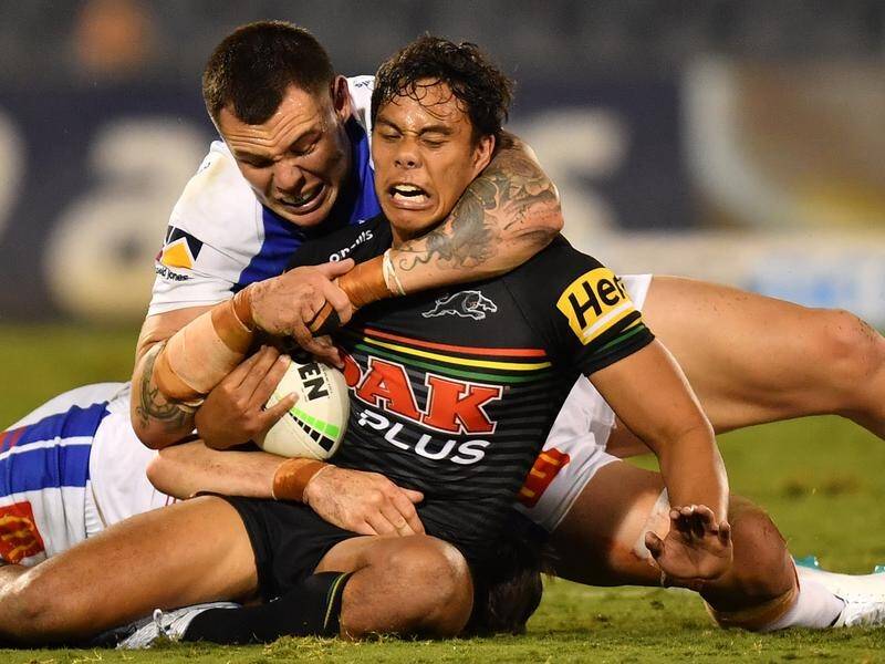 Jarome Luai is tackled by David Klemmer as the Panthers and Knights drew their NRL match.