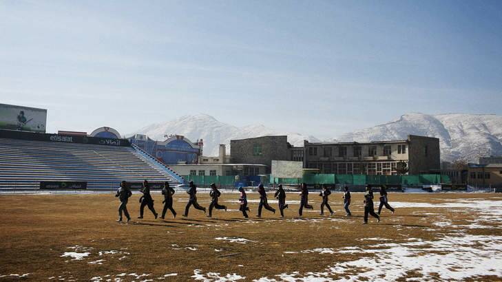 League of their own: The Afghan Women's Cricket team trains on a snow-covered Kabul Cricket Stadium in Afghanistan's capital. Photo: Andrew Quilty/Oculi