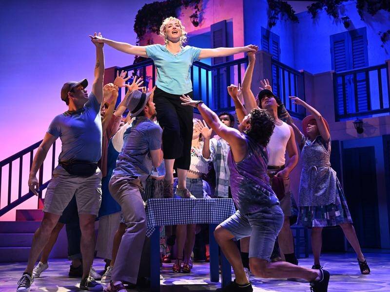 Cast members including Elise McCann (centre), who plays Donna Sheridan, rehearse for Mamma Mia! (Darren England/AAP PHOTOS)