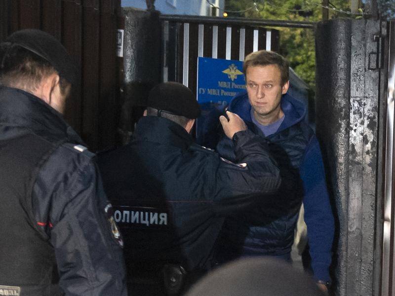 Police took Alexei Navalny away just as he emerged from a detention centre in Moscow.