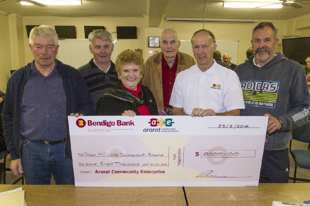 Tony Reynolds, Morrie Allgood, Peter Daman and Gwenda Allgood receive a donation for the Green Hill Lake Development Board from Ararat Community Enterprise members Russell Pearse and Michael Spalding.