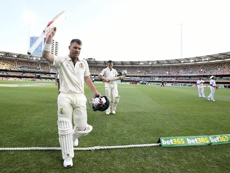 David Warner takes the applause for his epic first-Test knock after leaving the field at the Gabba.