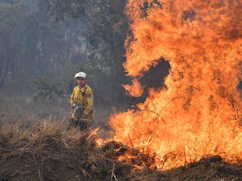 Firefighters undertook back-burning around NSW, with warm and windy conditions expected to return.