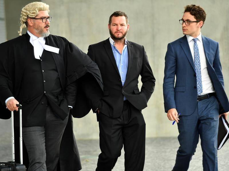 Aaron Colin East (centre) has pleaded not guilty to fraud charges over an alleged cold-call scam.