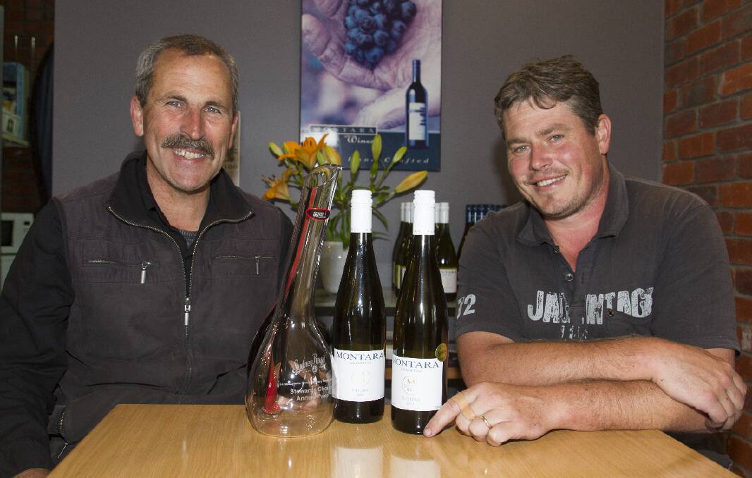Winemakers Leigh Clarnette and Ben Howell from the Montara Winery with the prize winning Montara wine and the award trophy. Picture: PETER PICKERING.