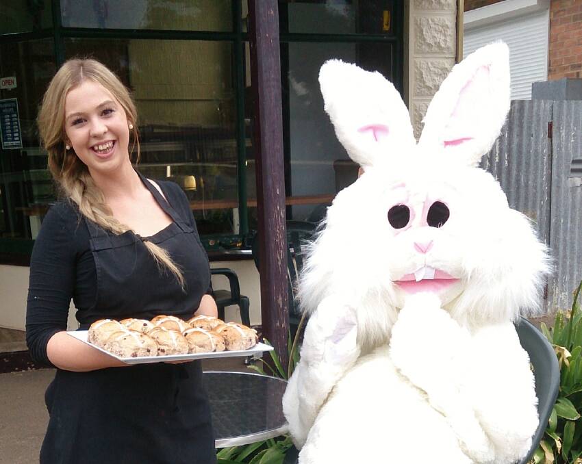 Willaura baker, Cassie Jaensch, offers the Easter bunny a tray of hot cross
buns, as they prepare for Willaura’s luncheon and children’s fun day on Good Friday.