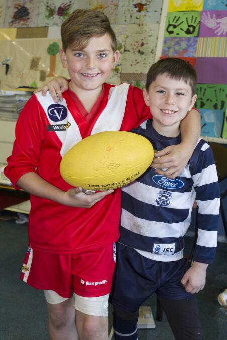 Bohdi and Saxon enjoying a 'footy colours' day at the Ararat YMCA Vacation Care program. Picture: PETER PICKERING.