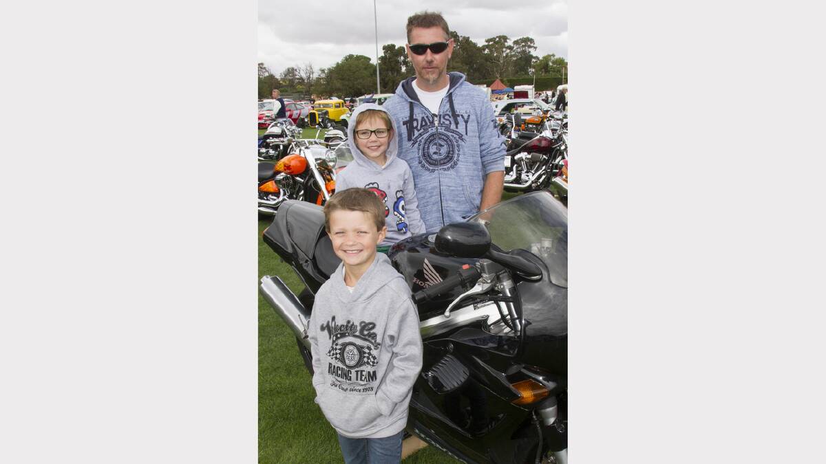 Wayne Keith with Riley and Noah on his motorbike.