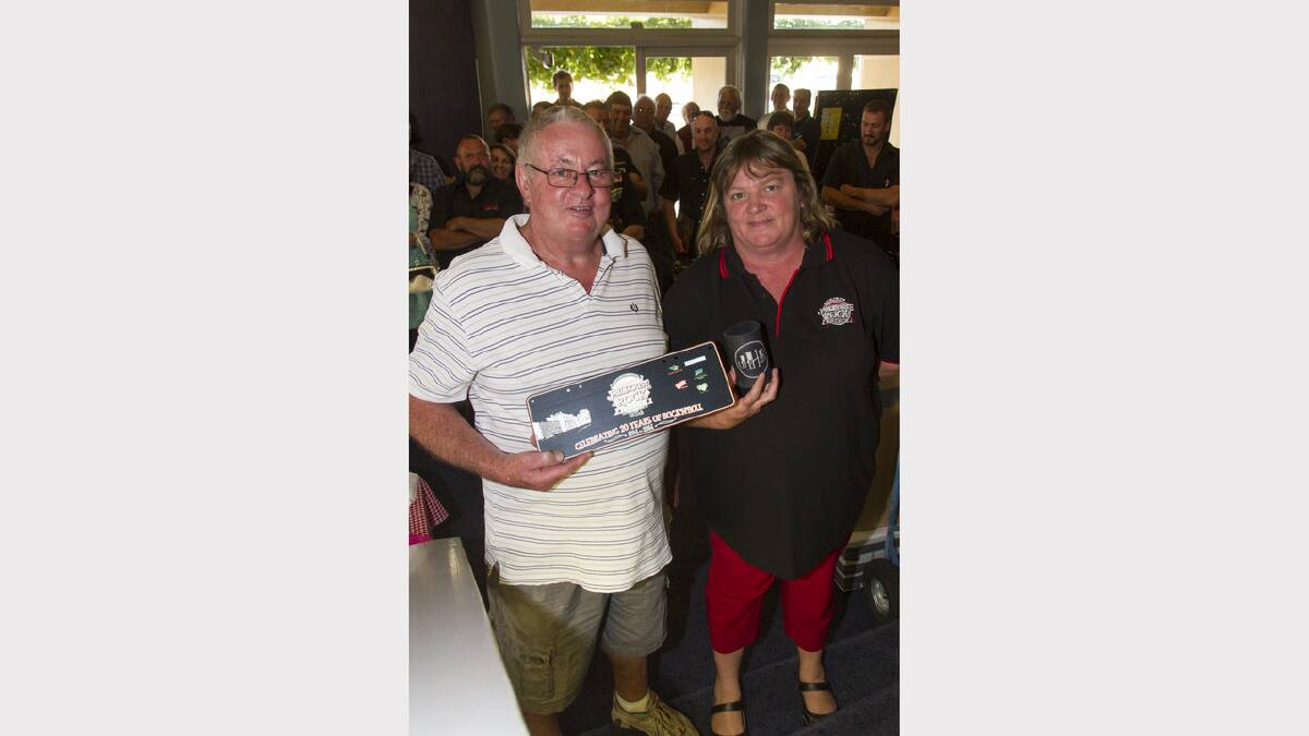Sandra Walker at left presented Barry Byron with a commemorative number plate for his assistance with the festival.