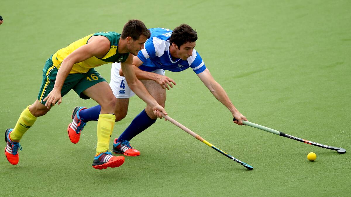 Matt Gohdes of Australia is challenged by Nicholas Parkes of Scotland during the men's preliminaries pool match between Australia and Scotland at the Glasgow National Hockey Centre during day eight of the Glasgow 2014 Commonwealth Games. PICTURE: GETTY