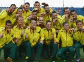 The Australian men's hockey team celebrate with their gold medals after winning the final against India. The Illawarra walked away with two gold medals from the match and one each for Newcastle and regional Western Australia. Photo: Getty Images