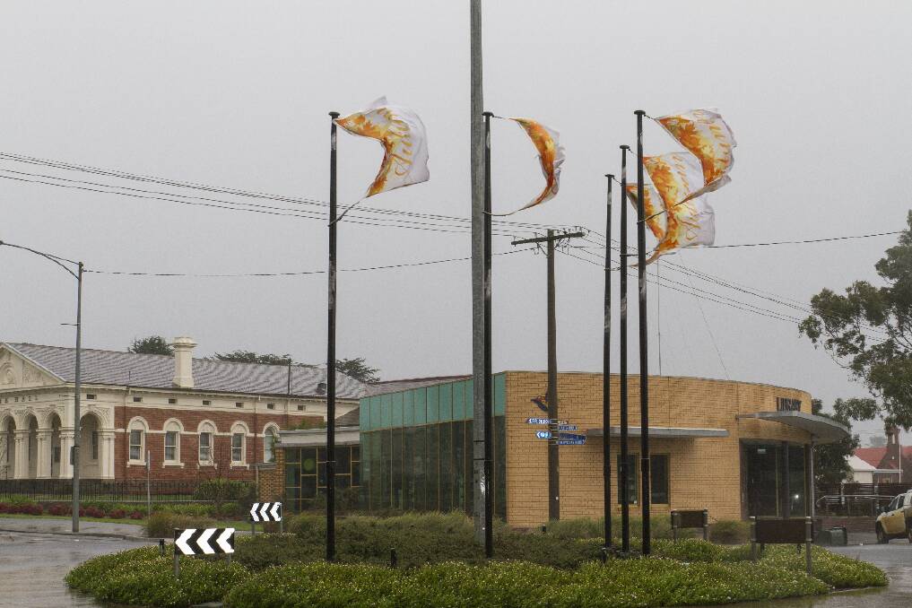 The flags in Barkly Street were almost torn off the flagpoles as a wild storm passed through the region on Tuesday morning. Picture: PETER PICKERING