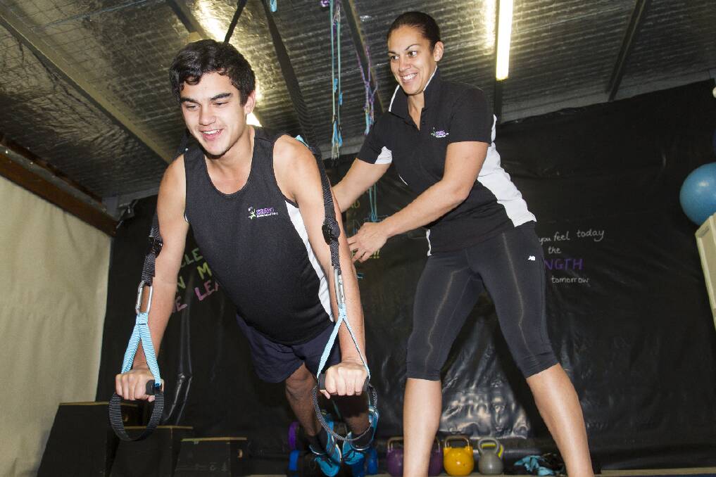 Lee-Ann Moana supervises Taine Pearse during a suspension training session.