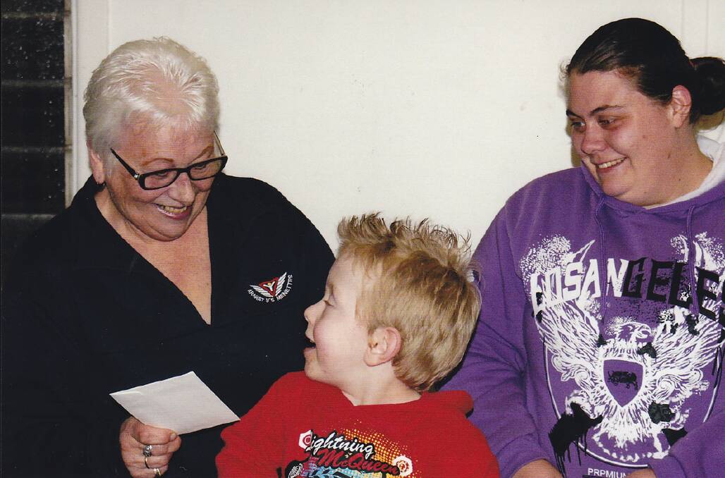President of the Y's Mennettes Club Krystyna Stigger presents an excited Jacob Warrior-Day and his mum Sarah with a cheque to help purchase a new wheelchair.