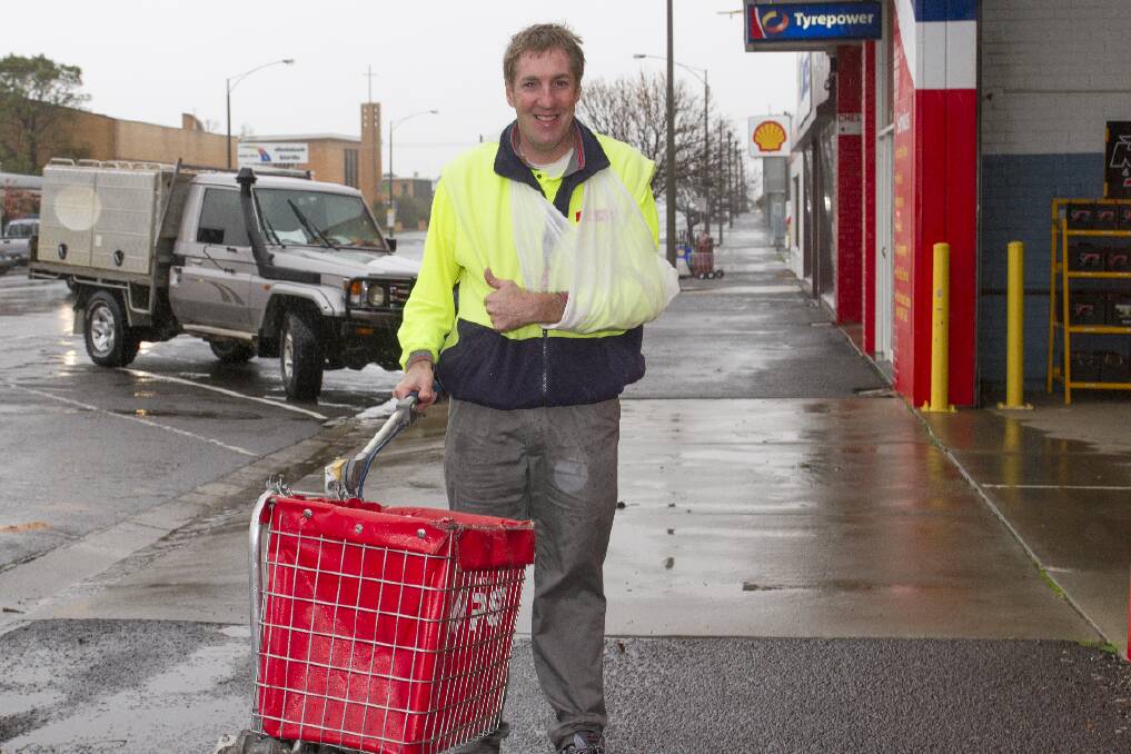 Postie David Rosengreen was the only person with the courage to brave a wet and windswept Barkly Street on Tuesday and kept up the post delivery despite the rain and wind. Picture: PETER PICKERING