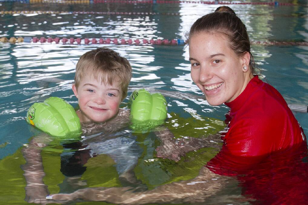 One of four 2015 Ararat YMCA Swimathon ambassadors Lachie with swimming instructor Emily Farmer. Picture: PETER PICKERING