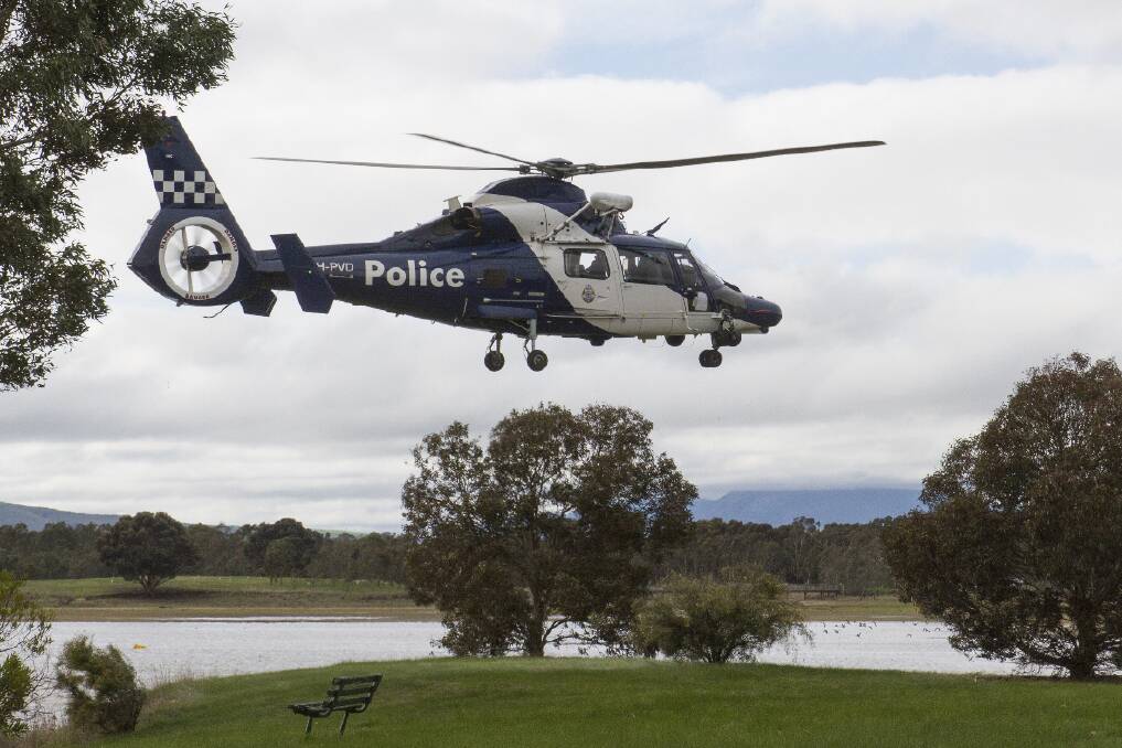 The police airwing helicopter hovers over Green Hill Lake during the search for Andrew Darling, who left Corella Place early on Sunday morning. Picture: PETER PICKERING
