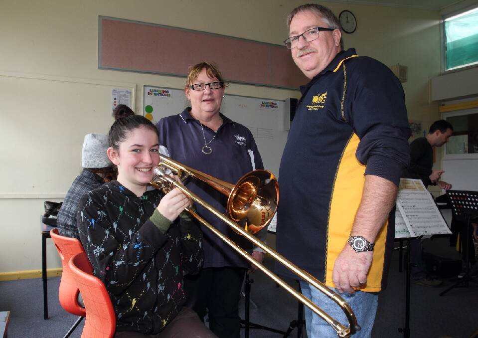 Evenne on the slide trombone with music school facilitators Jane and Peter Battersby.