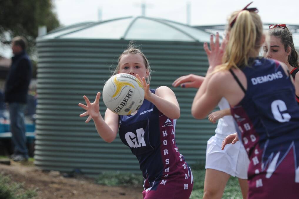 CATCH: Bethany Horton playing in the 2015 under-15 grand final. Horton will play for the Demons in the under-17 grand final on Saturday. Picture: SAMANTHA CAMARRI