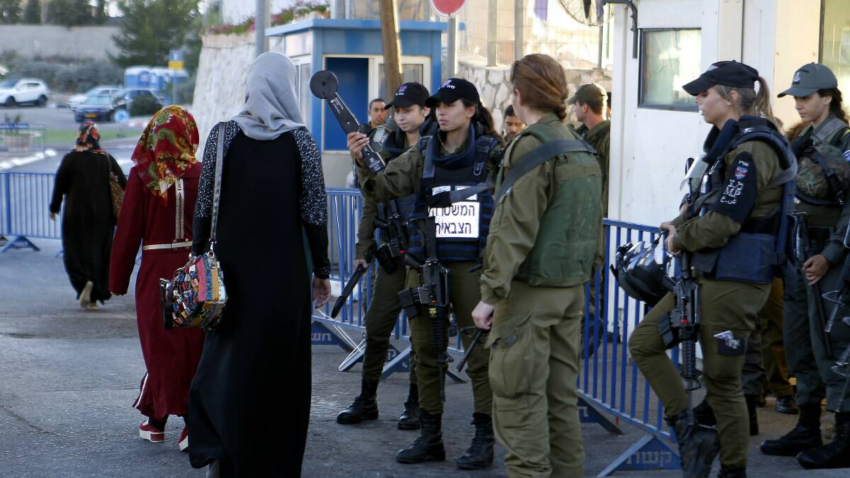 Israeli soldiers check Palestinian women who want to visit Al-Aqsa Mosque on the first Friday of Ramadan in 2016. Picture: Getty Images