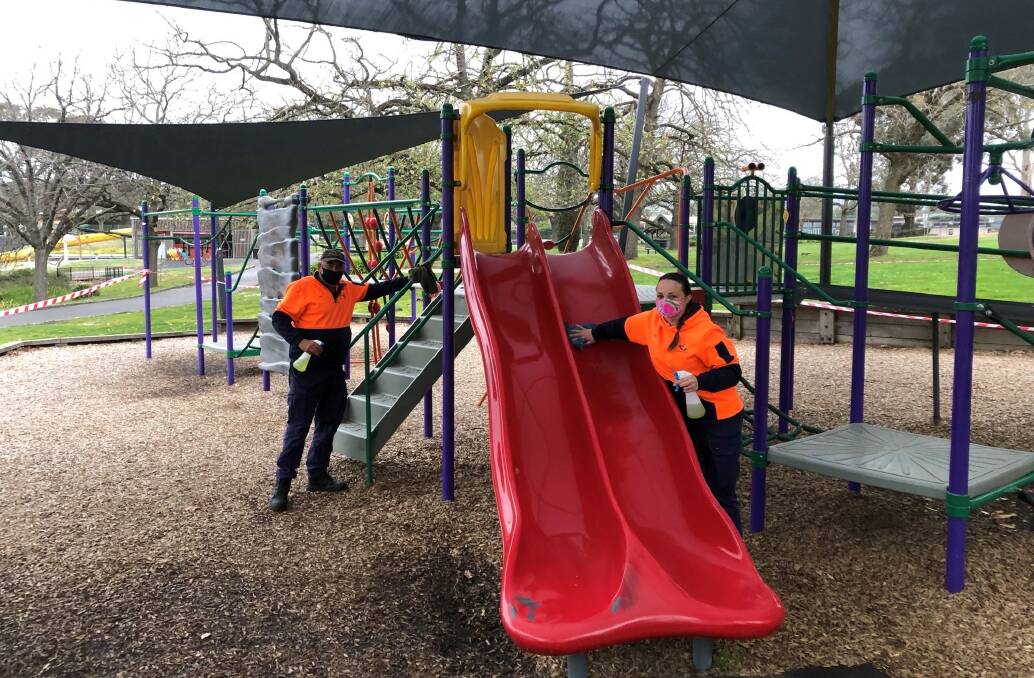 SAFETY FIRST: Ararat Rural City Council's park and garden workers, Craig and Shree, preparing the playground for reopening. Picture: ARCC