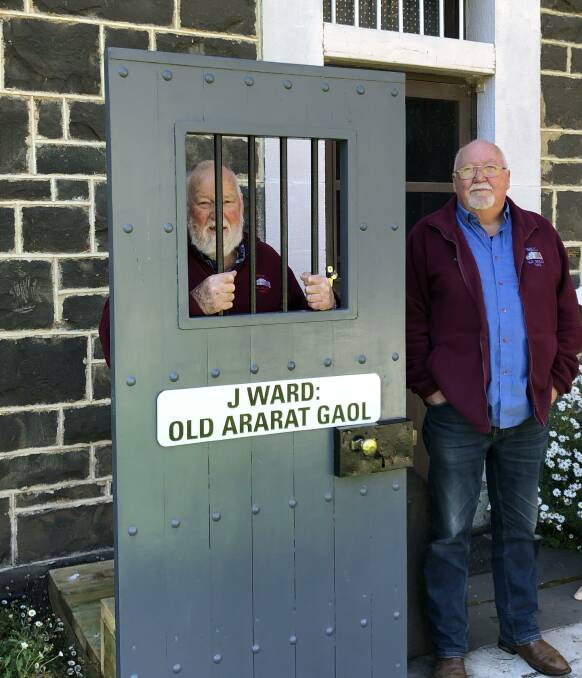 BEHIND BARS: (left to right) Friends of J Ward volunteers Ron Roberts and Alan Stewart. Picture: PAULINE ROBERTS