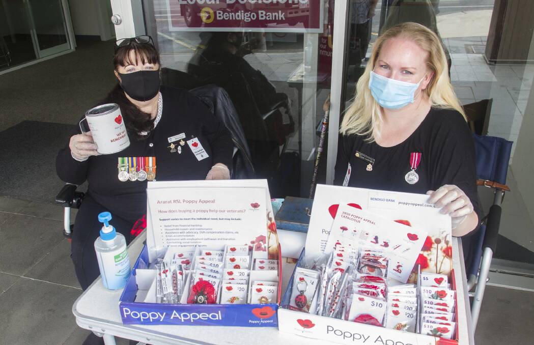 LEST WE FORGET: Ararat RSL volunteers Helene Krotz and Sarah Anderson at Bendigo Bank selling items for Poppy Appeal. Picture: PETER PICKERING 