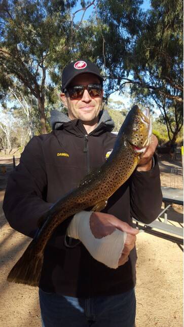 CATCH: Damien Keirl, with his 55cm brown trout.
