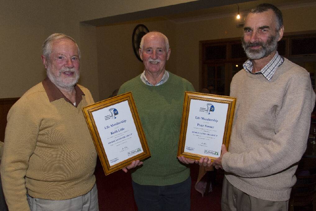 Keith Little and Peter Forster receive their life memberships from Ararat Landcare Group president Ian Foster. Picture: PETER PICKERING