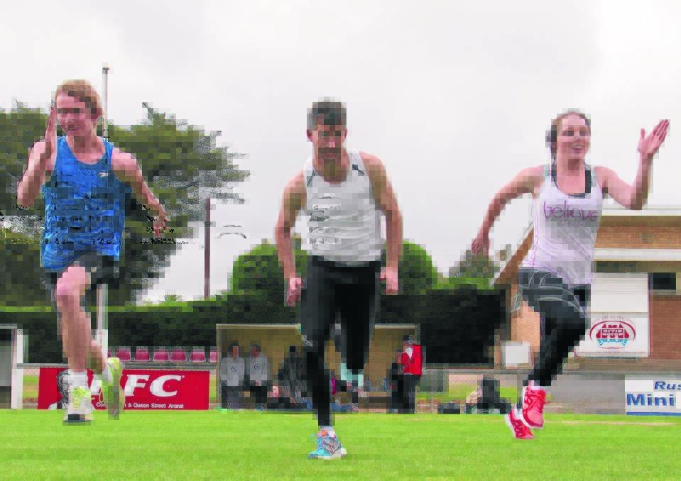 Marcus Cooper (centre) and two of his stable of runners Corey Heard and Georgia Notting in training for the 2012/2013 Victorian Athletic League season.