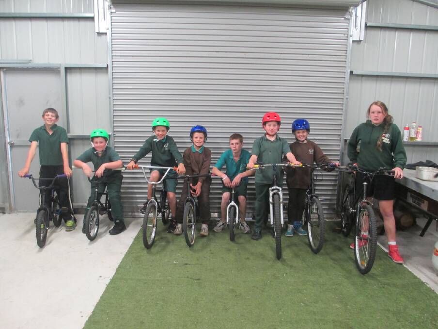 Pictured L-R, Tyson, Kyle, Zac, Michael, Jesse, Seth, Amelia and Katelyn with their bikes.