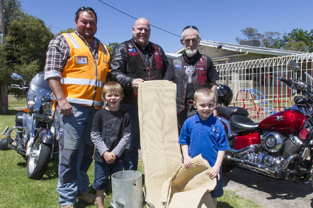 Mick Edwards, Josh Drewniak and Danny Jeans with Ethan and Charlie and the materials for the shade sail.  
 Picture: PETER PICKERING