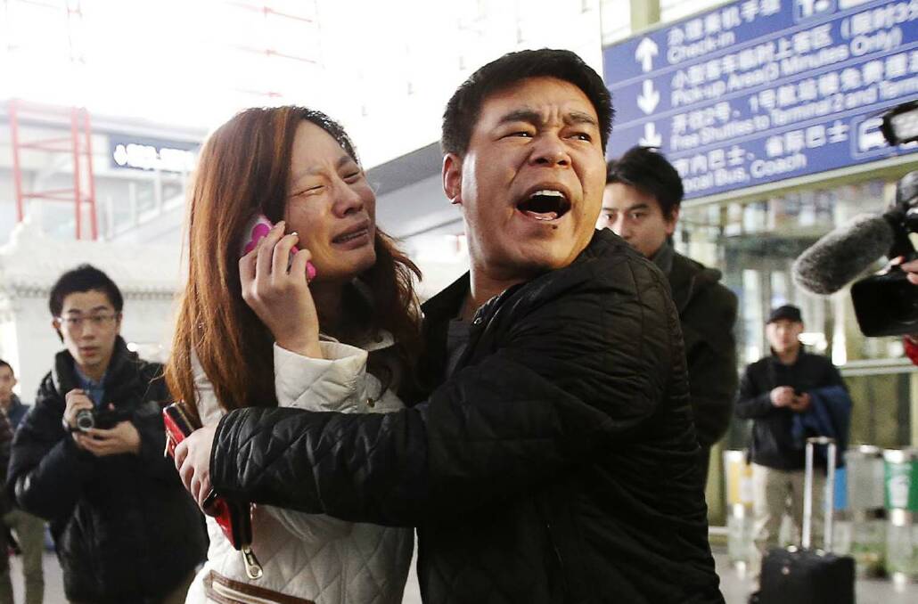 A woman (C), believed to be the relative of a passenger onboard Malaysia Airlines flight MH370, cries as she talks on her mobile phone at the Beijing Capital International Airport in Beijing, March 8, 2014. The Malaysia Airlines Boeing B777-200 aircraft carrying 227 passengers and 12 crew lost contact with air traffic controllers early on Saturday en route from Kuala Lumpur to Beijing, the airline said in a statement. REUTERS/Kim Kyung-Hoon (CHINA - Tags: TRANSPORT DISASTER) Photo: KIM KYUNG-HOON
