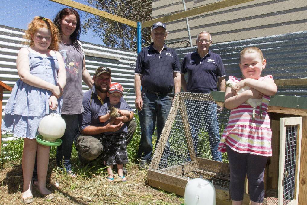 Finley, Lauren Smithwick, Ben Fenn, Rusty with a chicken of the same name, Ivan Cocking, Charlie Martin and Lainey in the Carey Street Kinder chook pen. Picture: PETER PICKERING