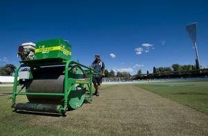 On a roll: Manuka Oval curator puts the roller over the pitch on Tuesday. Photo: Elesa Kurtz