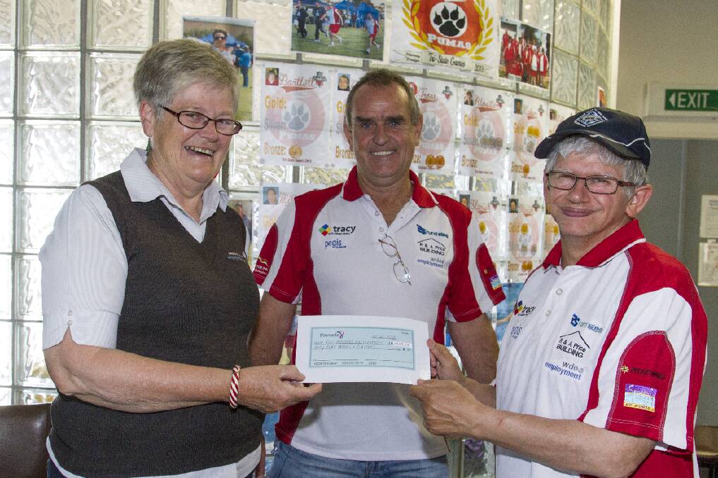 Maureen Brady presents a cheque to Daryl Baldock and Micky at Pinnacle Inc.