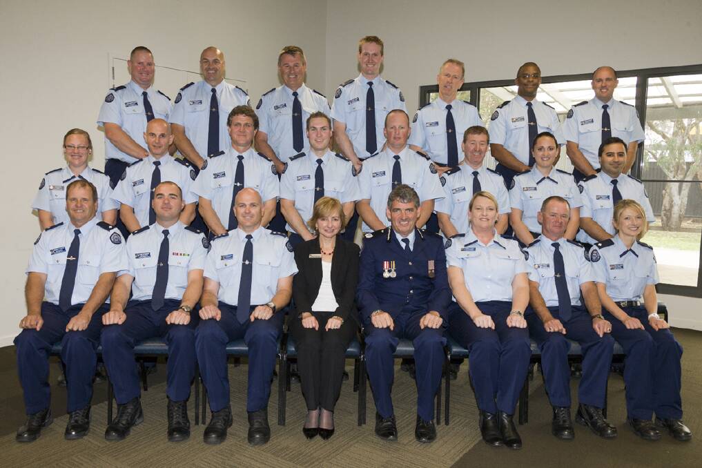 The graduating squad of 19 with their training offi cers and Grampians Regional Director Catherine Darbyshire (middle left seated) and general manager Pat McCormick (middle right seated)