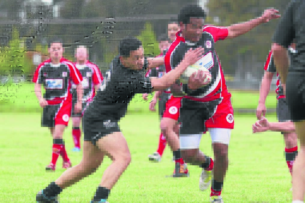 DARE DEVIL: Ararat/Stawell Devils Josh Nadalo muscles his way past Victoria Police Vikings Amanaki Holani during Saturday s inaugural Blue Ribbon Rugby League Cup at Gordon Street Oval. Picture: PETER PICKERING.
