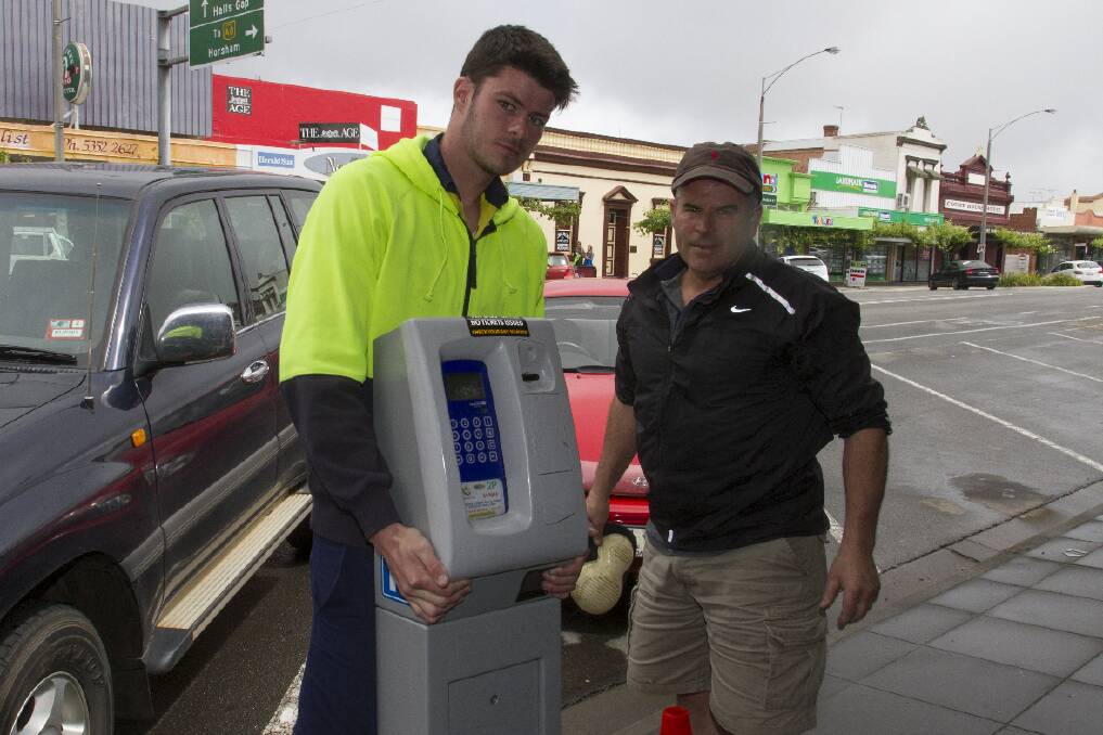 Parker and Michael Sneddon replace the parking meters in Barkly Street. Picture: PETER PICKERING