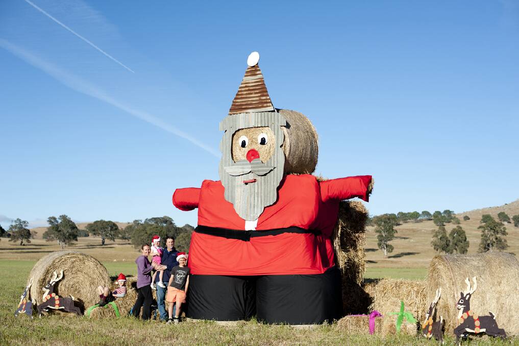 A giant Santa assembled with hay bales and material including the black backdrop of a photography studio as pants has made an appearance on the Conboy's property.