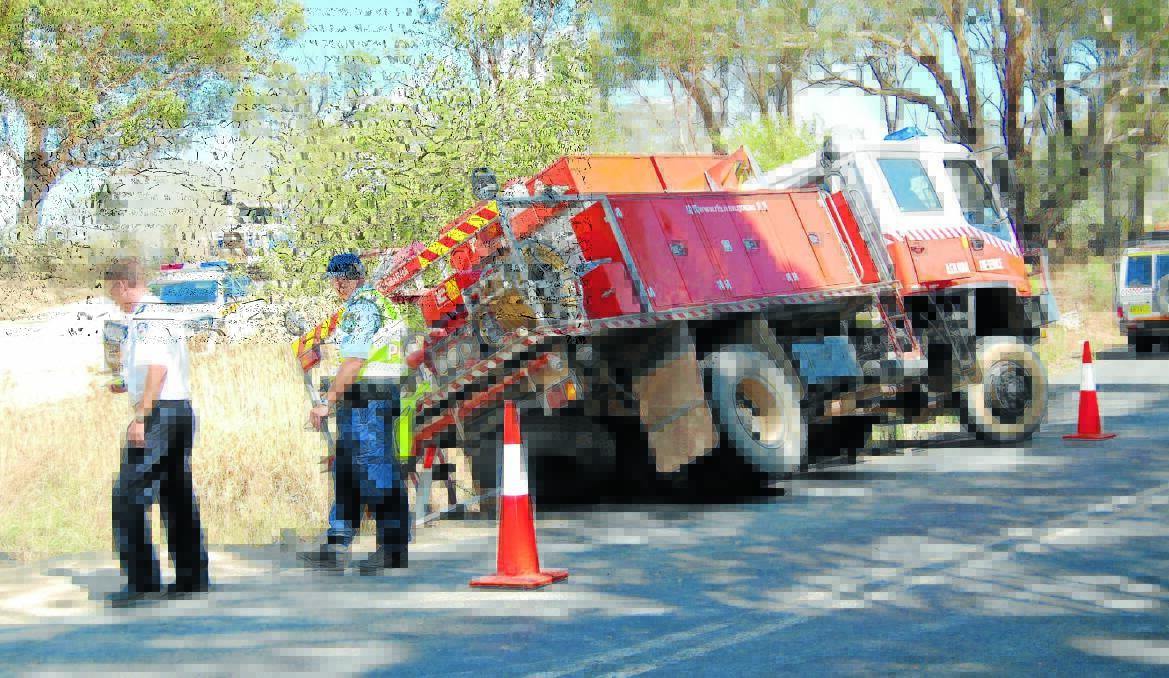 LAST DITCH ATTEMPT: The Muogamarra Rural Fire Brigade's truck from Sydney escaped damage when it ended up in a ditch while firefighters were fighting a fire near Trunkey Creek. No one was injured during the incident. Photo: BRYANT HEVESI 0123tanker