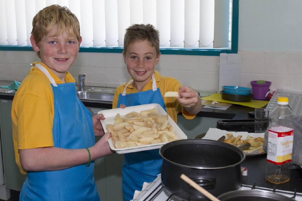 These will taste great - Zac and Jacob prepare the potato wedges.