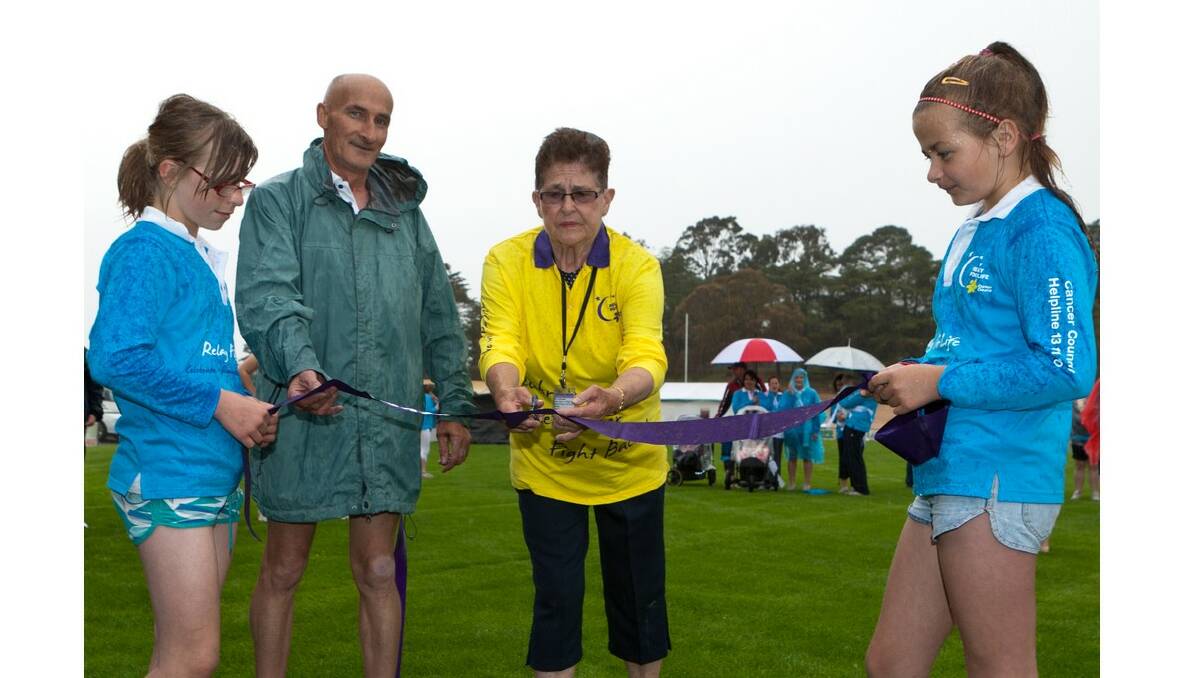 Sophie and Candice and Relay for Life veteran Michael Grayly hold the ribbon being cut by Margaret Dunmore during Ararat's 2010 event.