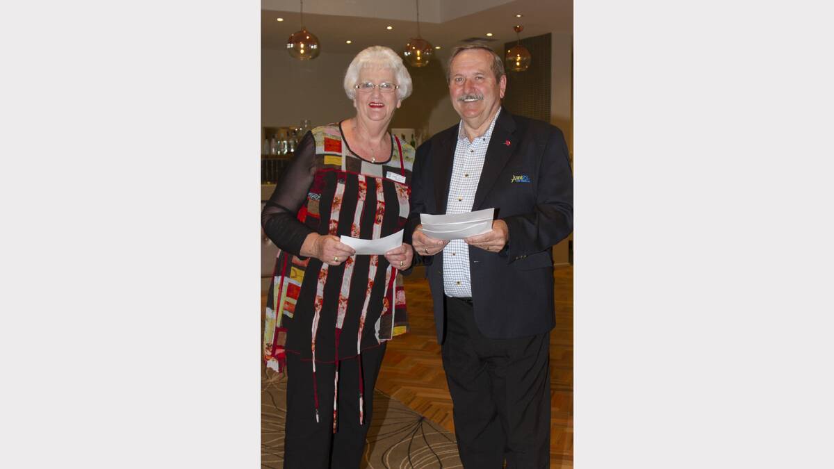 Anne Joyce receives a RSL grant for the Catholic Women's League from Frank Neulist.