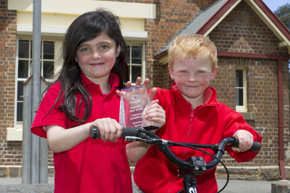 Young riders Aaliyah and Lane with the trophy won by the Moyston Primary School at the BMX racing championships. Picture: PETER PICKERING
