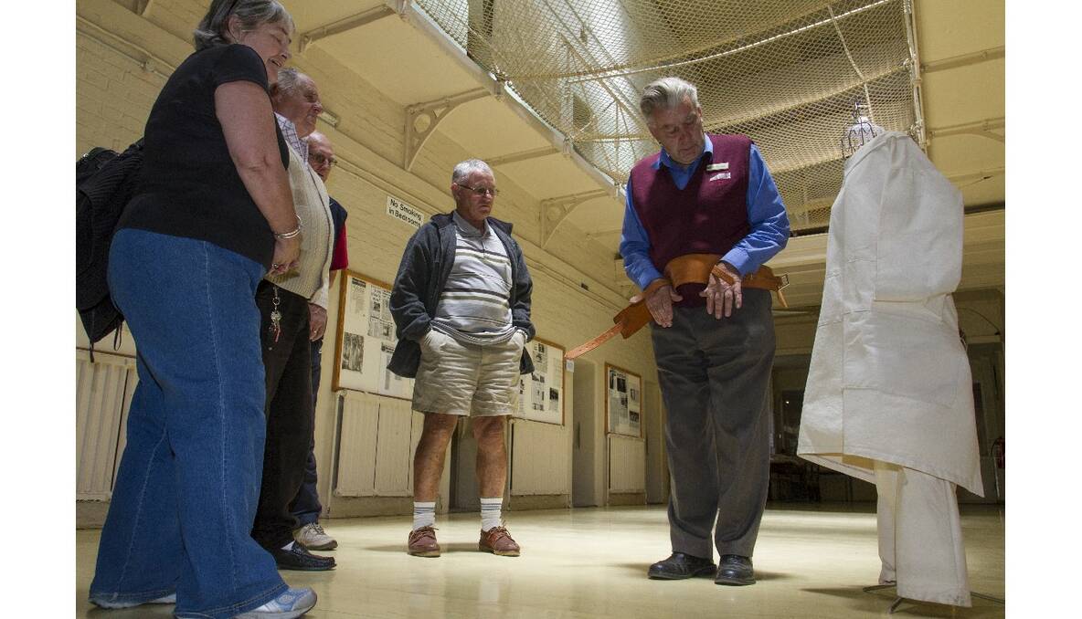 J Ward tour guide George Dunkling demonstrates an item used in the days when the old gaol was a prison for the criminally insane. The J Ward tours attract hundreds of tourists to Ararat every holiday period. Picture: PETER PICKERING
